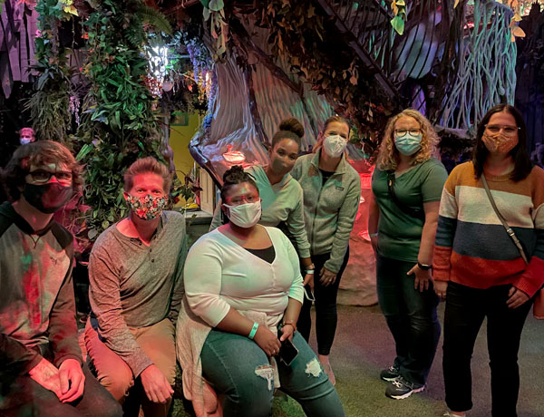 a group photo of xd students in santa fe inside a museum