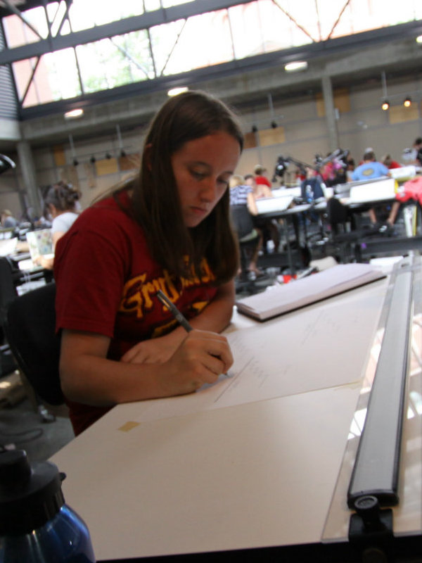 female student working at drawing board