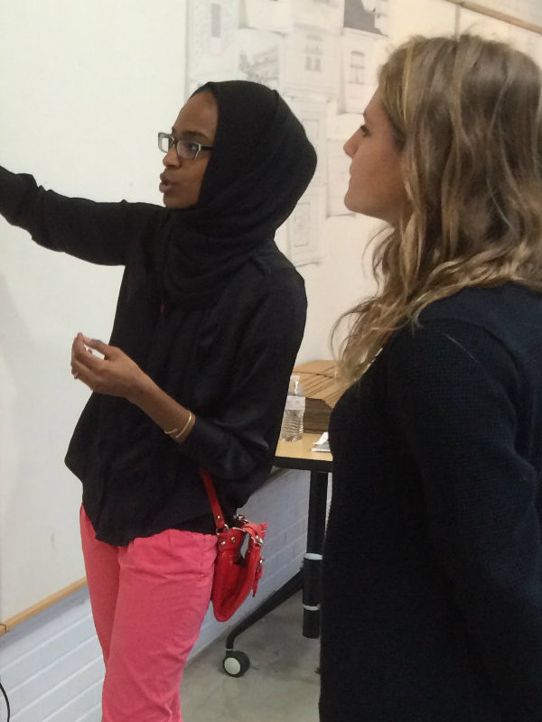 female student presenting to female faculty member