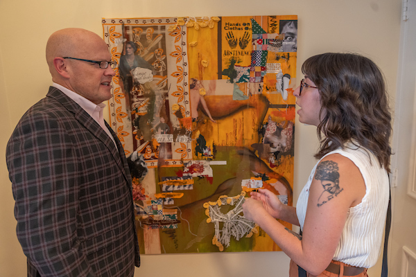 a student talking to president crawford about a painting
