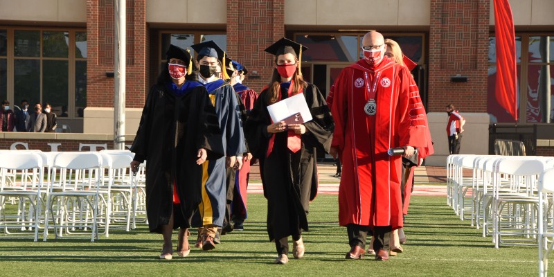 President Crawford walking with CEC faculty