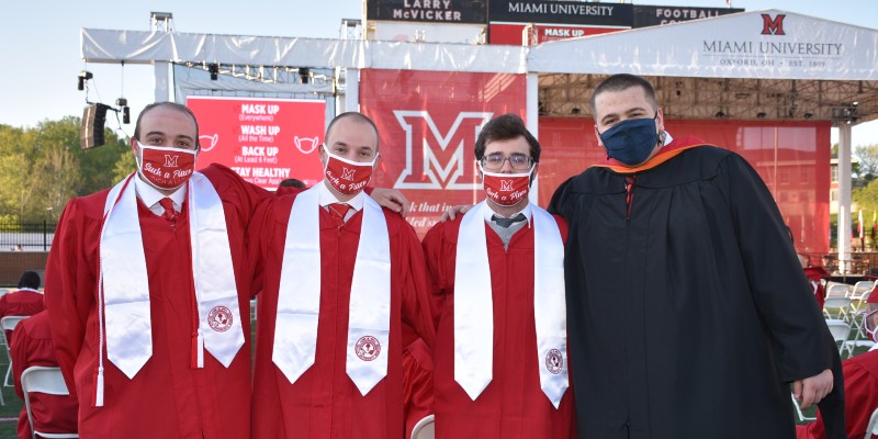Four students wearing masks before the graduation ceremony