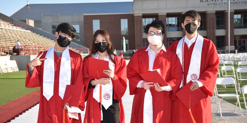 Four graduates before the ceremony