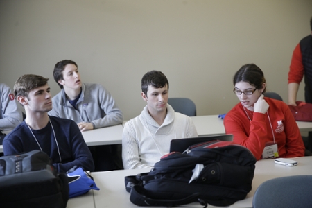 Students looking at computers in a classroom