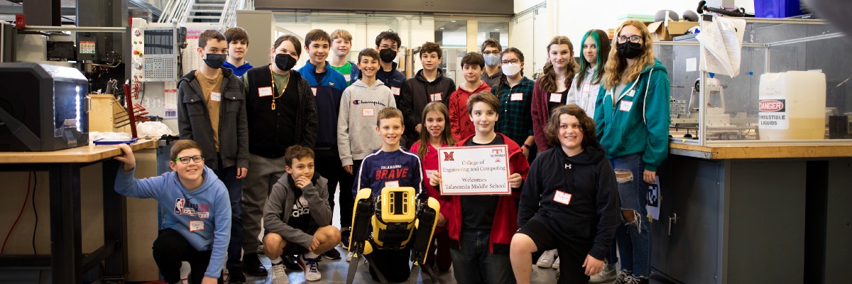  Talawanda Middle School students take a group photo with a robotic dog
