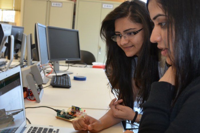 Dr. Rajasehkar and a female student looking at a computer