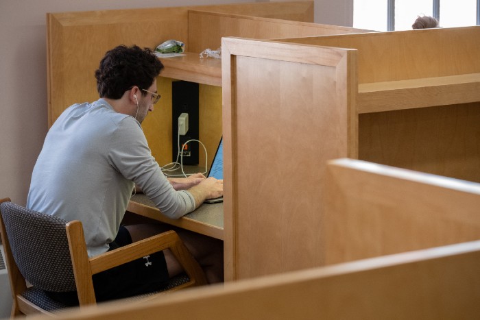 Student studying in a library study area