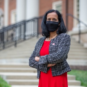 Dean Sukumaran in front of Benton Hall, wearing a mask