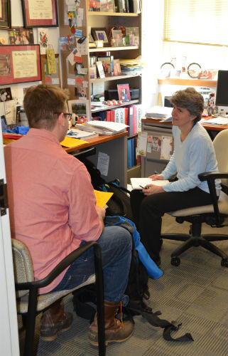 Dr. Almquist in her office talking with a student