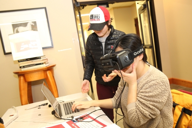Two students experiment with an Oculus virtual reality system