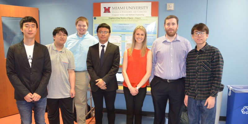 A group of ECE students in front of their senior design poster