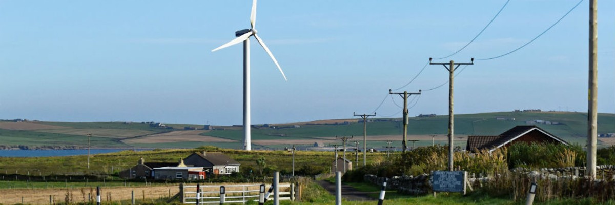  A wind turbine standing in the middle of a rural landscape