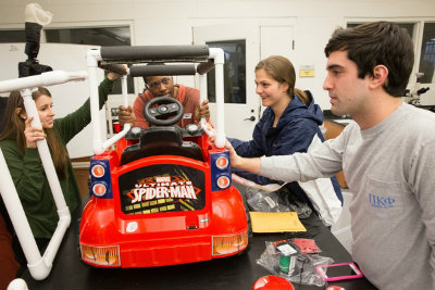 Team working on toy car for students with disabilities.