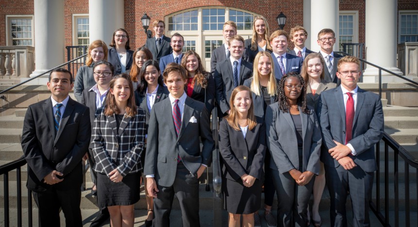 Group picture of cohort IX, standing in front of Benton Hall