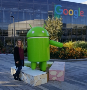 Emily in front of the Google building with the Android Robot