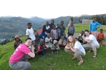 Kylie, Katie, and Kelsea pose with school kids