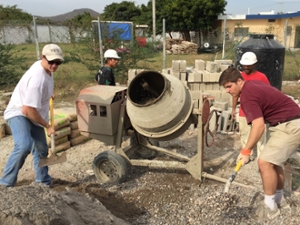 Miami students pour concrete at the orphanage 