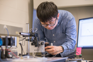 Male ECE student working on a lab