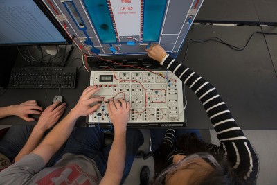 CPB students working with a machine during a lab