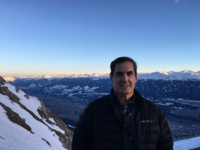 Dr. Keller standing in front of sky and mountain