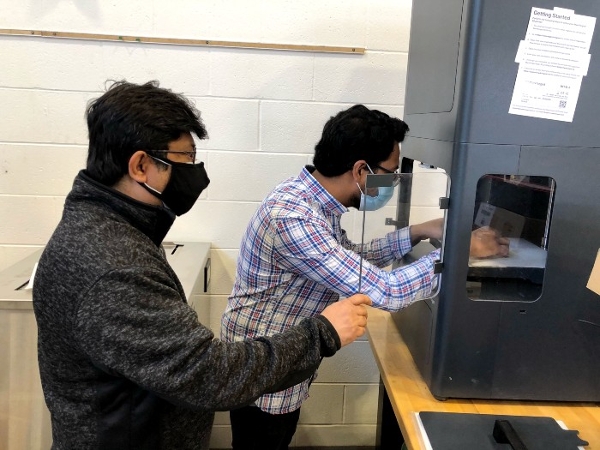 Dr. Jahan working with a student in a MME lab