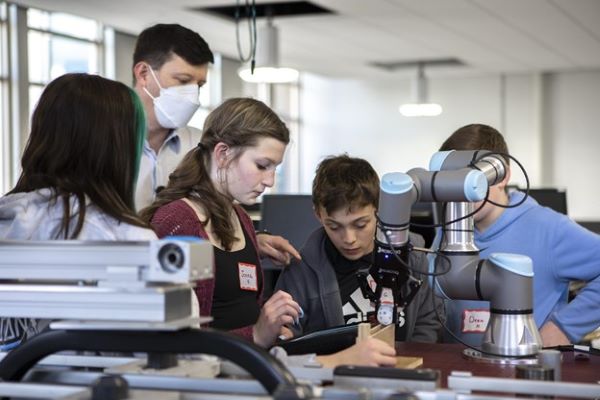 students working on a project for a disabled person