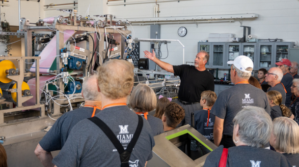 Doug Hart demonstrates the functionality of the Pilot Paper Machine to an assembly of grandparents and their grandchildren at Miami CEC.