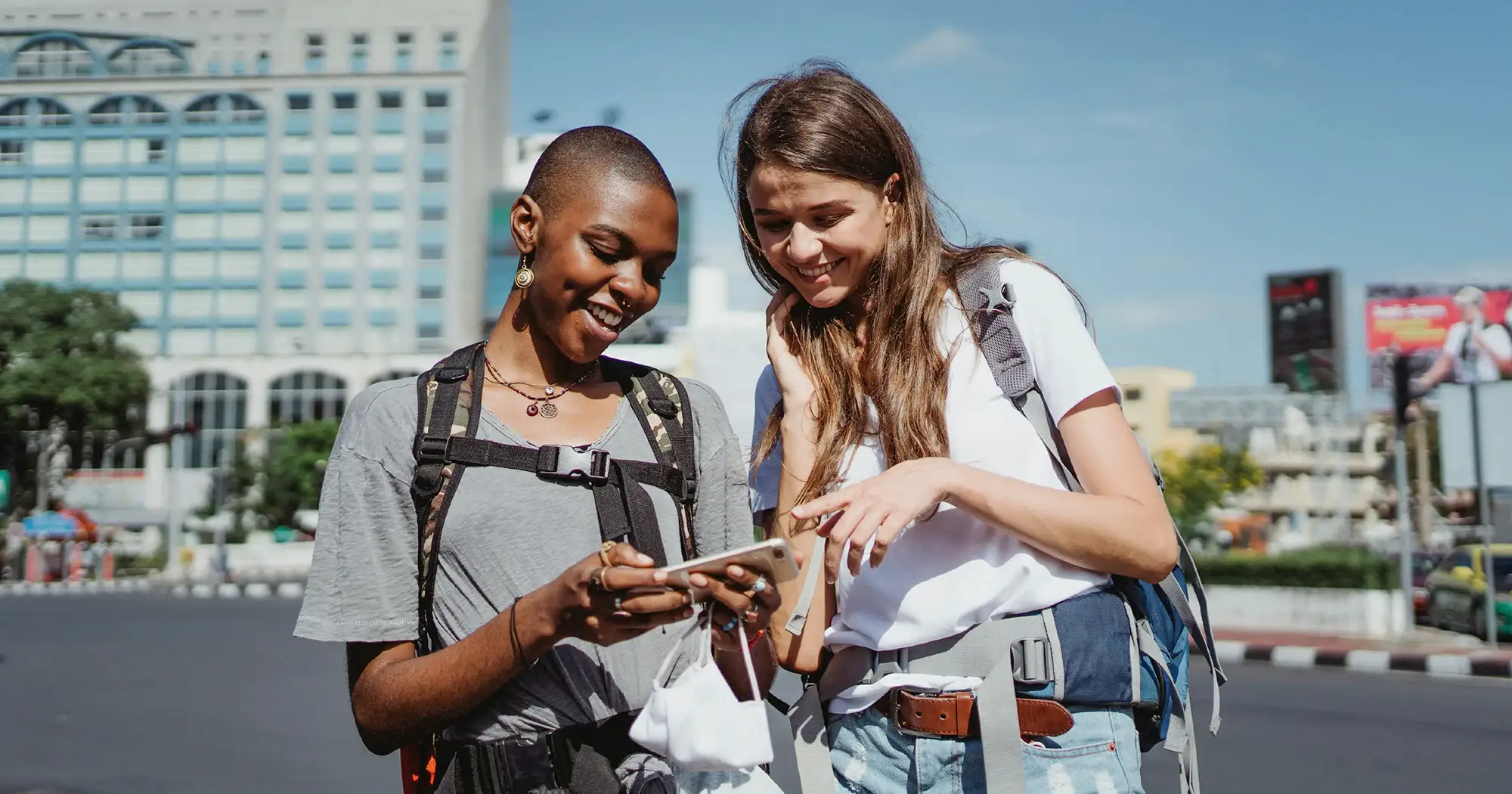 Two college girls looking at a smartphone