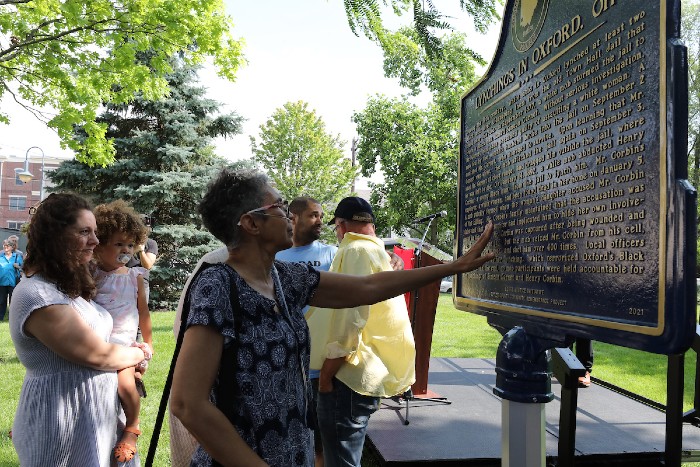 Descendants of the two lynched men standing in front of historical marker in their memory unveiled at Oxford Uptown park