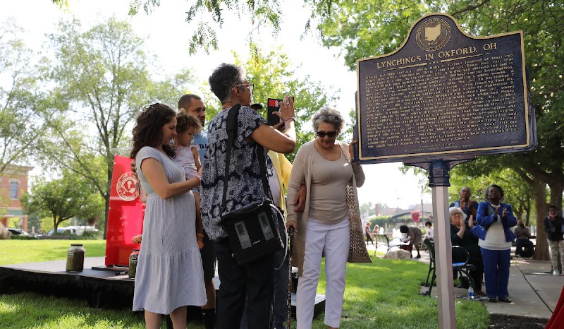Family members gathered around the marker