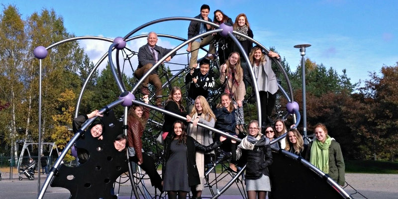 students take picture on a spherical object while studying abroad in Finland