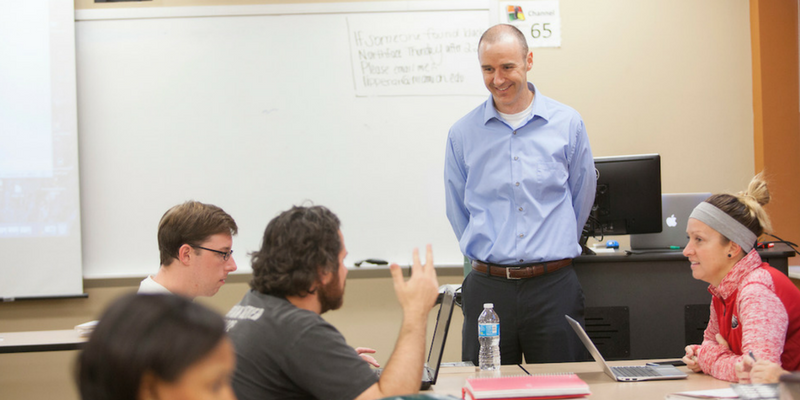 professor teaching class laughing with students