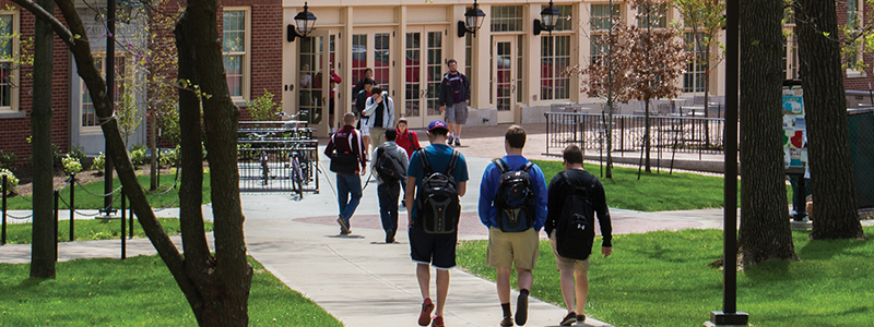 students walking on campus in the summer