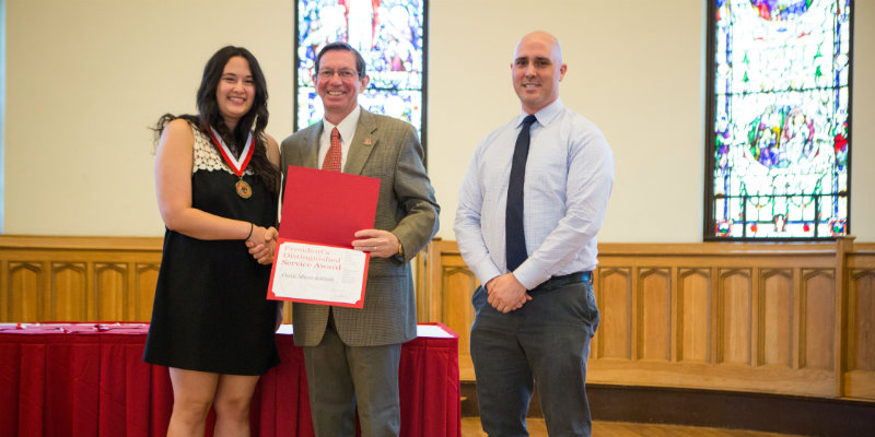 Casey Kaldahl with president Hodge and Dr. Michael Evans receiving her Presidential Distinguished Service Award