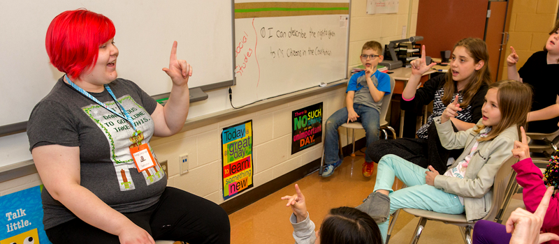 student teaching foreign language to group of children