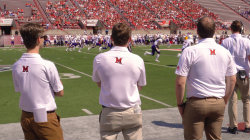 Students working at a Miami football game