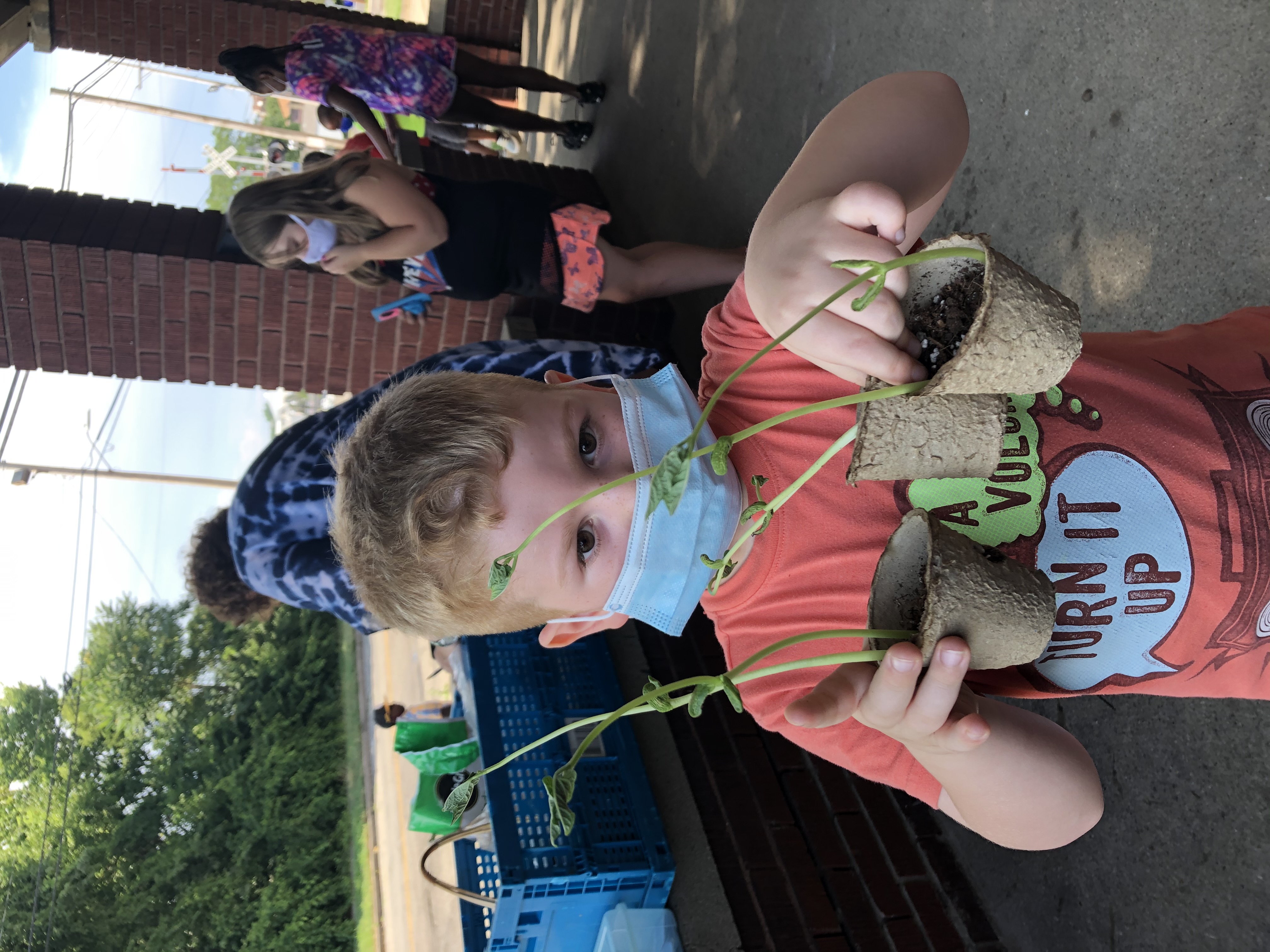 child holding plants