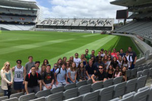 students take picture in stadium