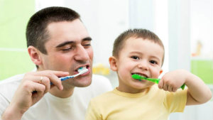 two people brushing their teeth