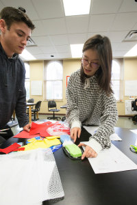 two students work together to make shoes