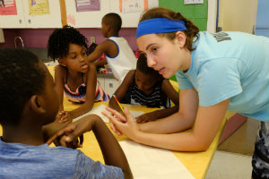 Urban Cohort program student talking with children