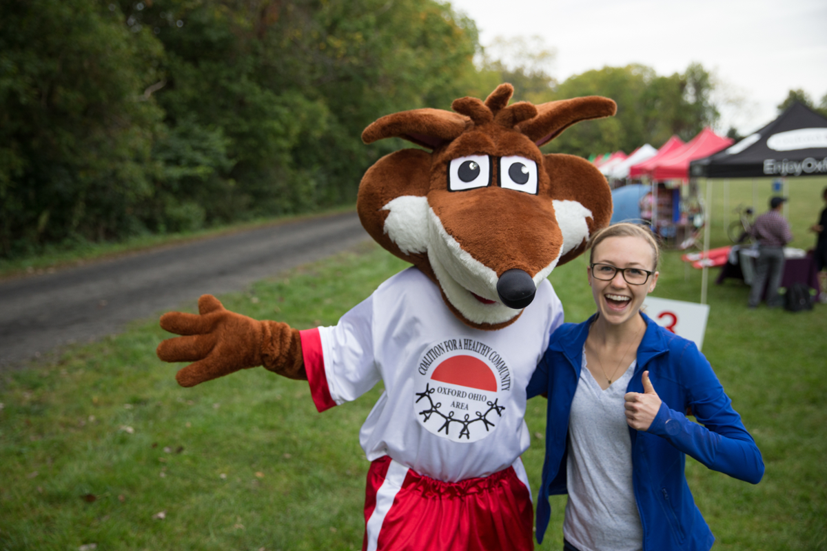 Rox the Fox taking photo with student