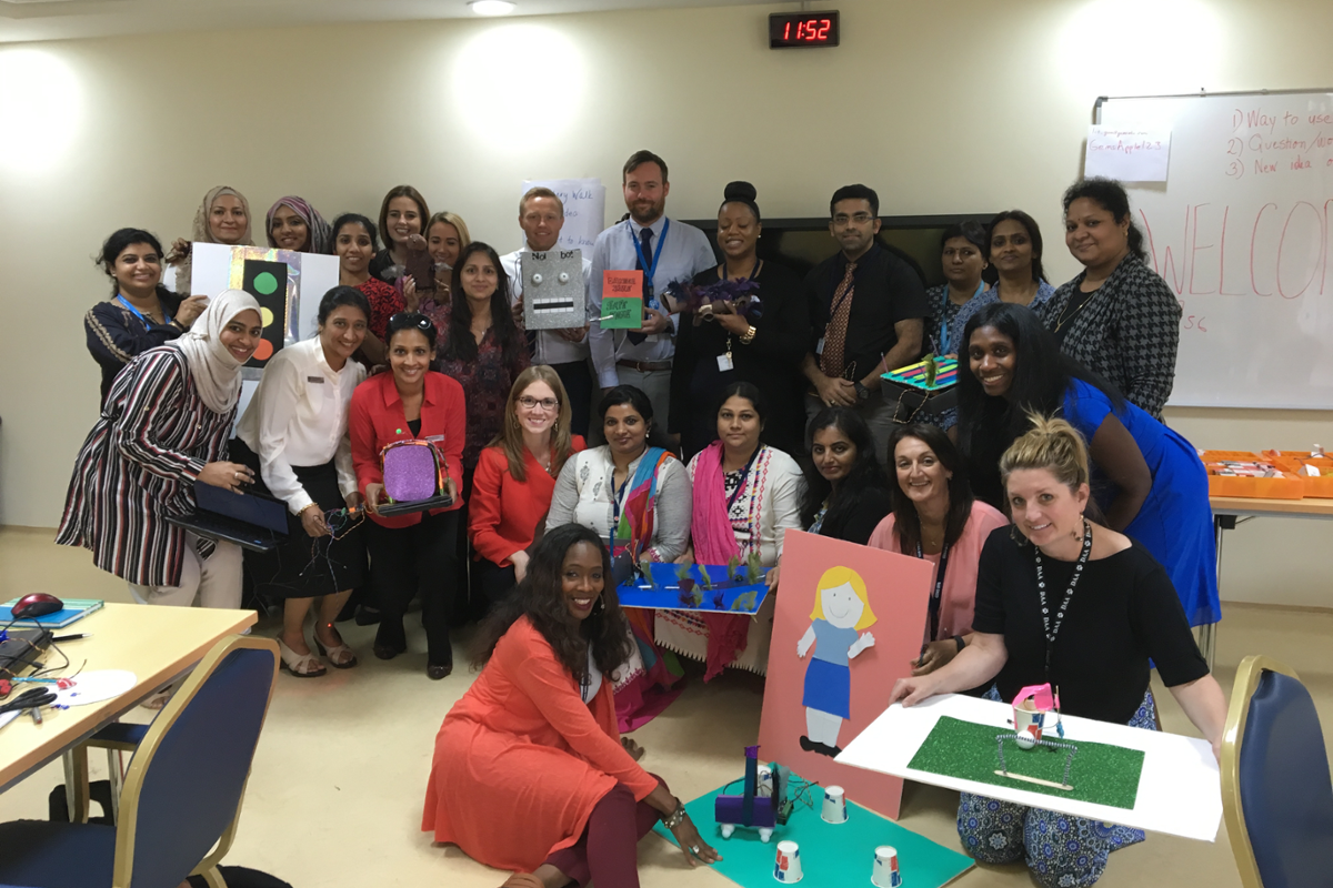 Katie Henry taking a picture with teachers in Dubai