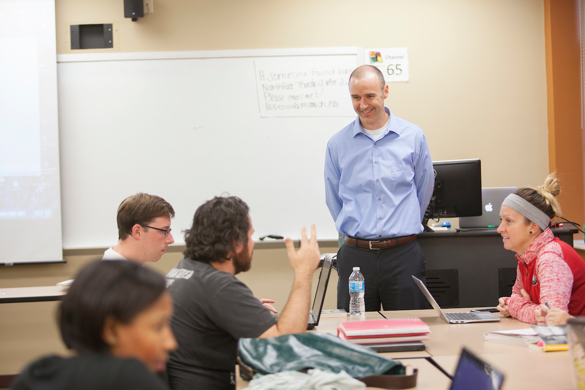 joel malin teaching in front of a classroom