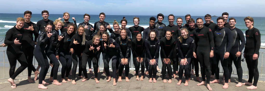  Students posing after surfing in New Zealand