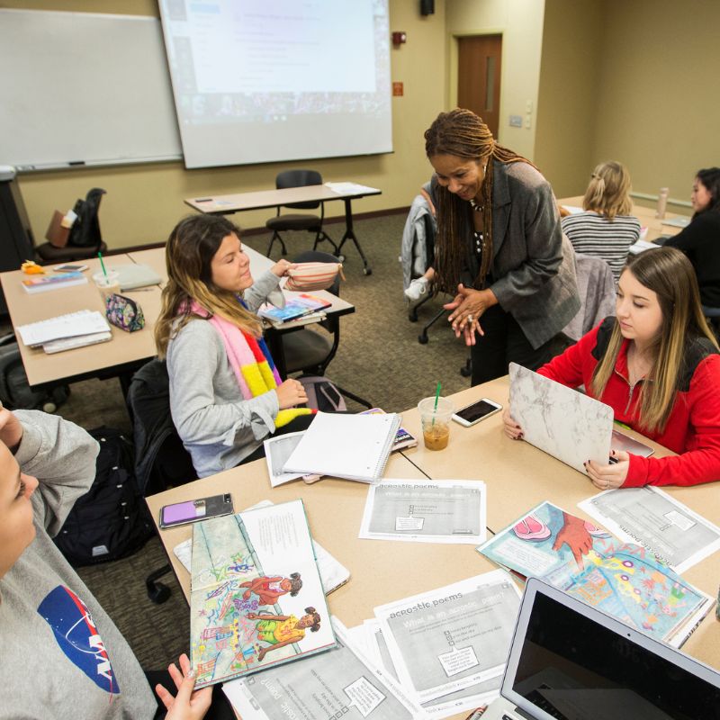 teacher working with students in a classroom