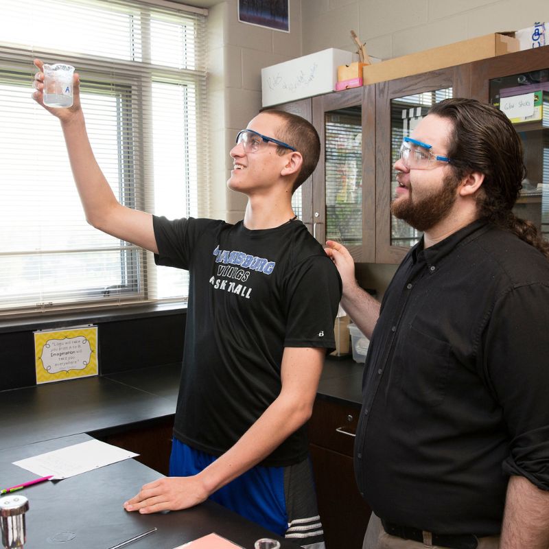 student observing something in a beaker