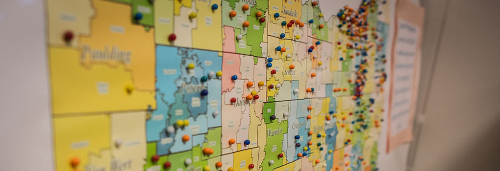 Map of Ohio with pushpins in assorted colors. 