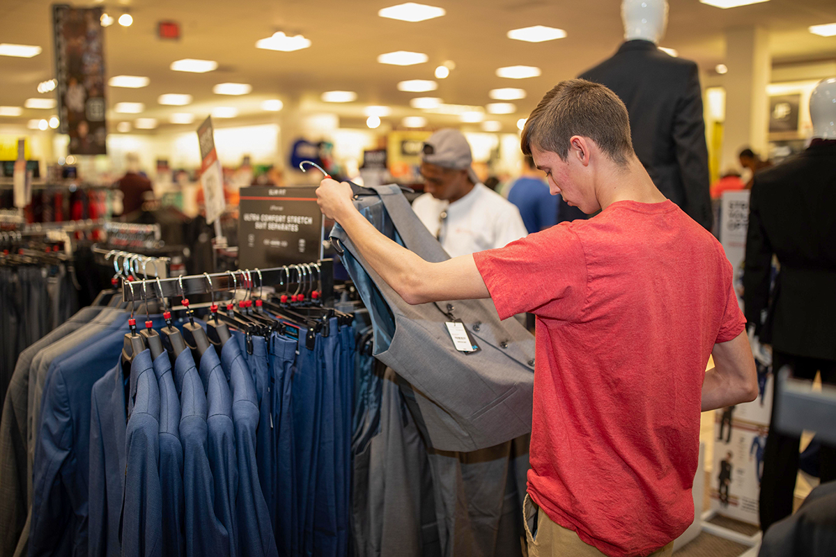 Photo of student looking through professional clothing