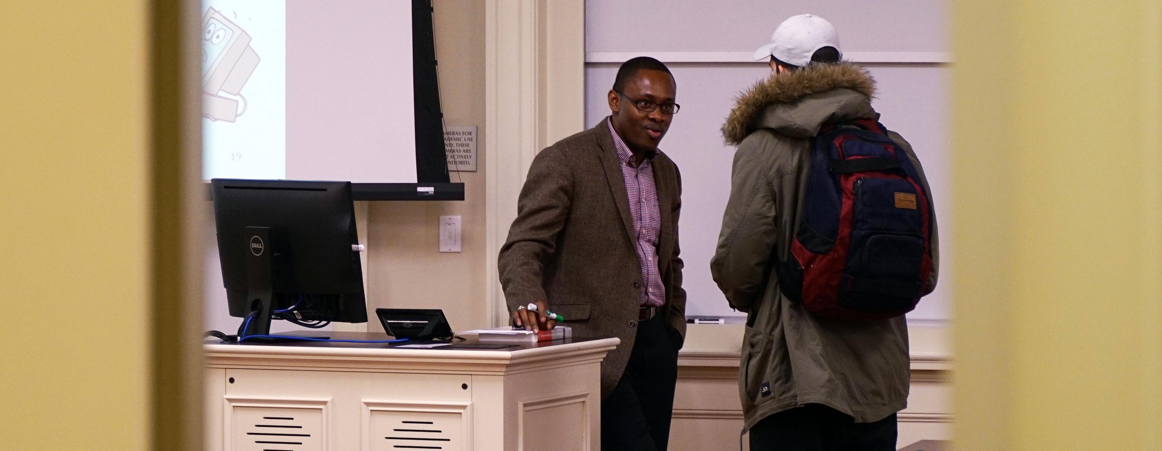 Dr. Joseph Nwankpa talks with a student after class